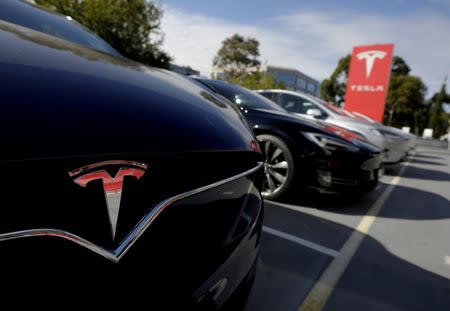 FILE PHOTO: A Tesla Model X is seen alongside a Model S at a Tesla electric car dealership in Sydney, Australia on May 31, 2017. REUTERS/Jason Reed//File Photo