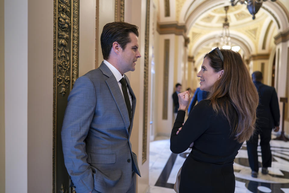 Rep. Matt Gaetz, R-Fla., and Rep. Nancy Mace, R-S.C., right, confer in the hallway near the House chamber just after a stopgap spending bill advanced on a procedural vote but with final passage uncertain, at the Capitol in Washington, Friday, Sept. 29, 2023. (AP Photo/J. Scott Applewhite)