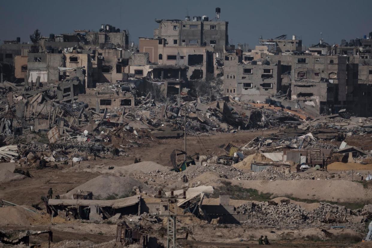 Israeli troops walk in the Gaza Strip as seen from southern Israel on Thursday, Dec. 21, 2023. (The Associated Press - image credit)