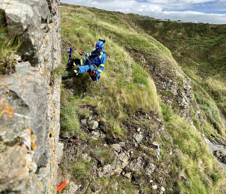 Coastguards lowered a rescue technician down to the man to help raise him to safety. (Facebook/HM Coastguard - Portpatrick)