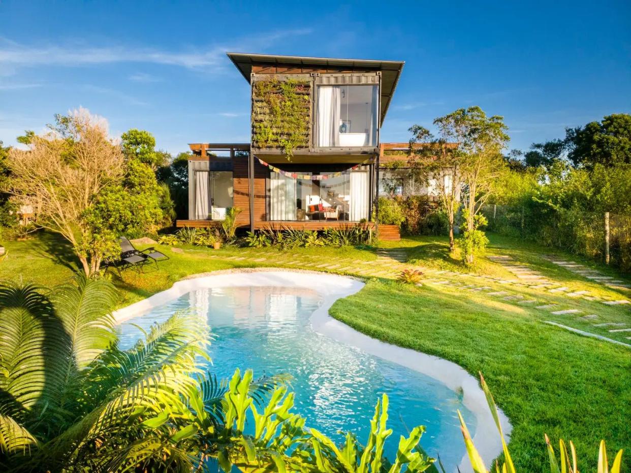 a house with a pond in front of it