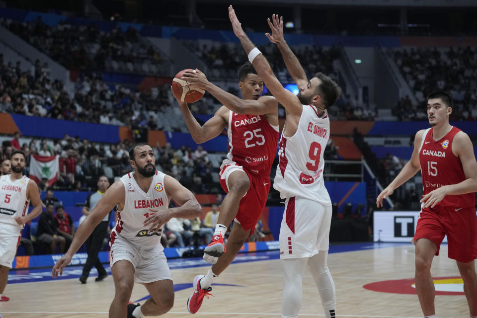 Canada guard Trae Bell-Haynes (25) drives agiainst Lebanon guard Sergio El Darwich (9) during the Basketball World Cup group H match between Canada and Lebanon at the Indonesia Arena stadium in Jakarta, Indonesia Sunday, Aug. 27, 2023. (AP Photo/Dita Alangkara)