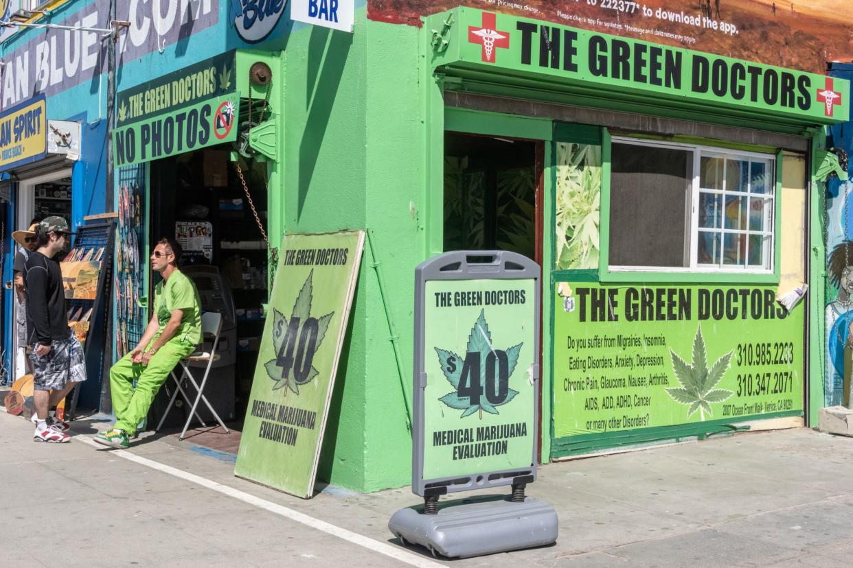 venice beach, california, usa - july 16, 2014:green doctors, typical medical marijuana dispensary on the boardwalk of venice beach, ca. a nurse is standing at the doctors office