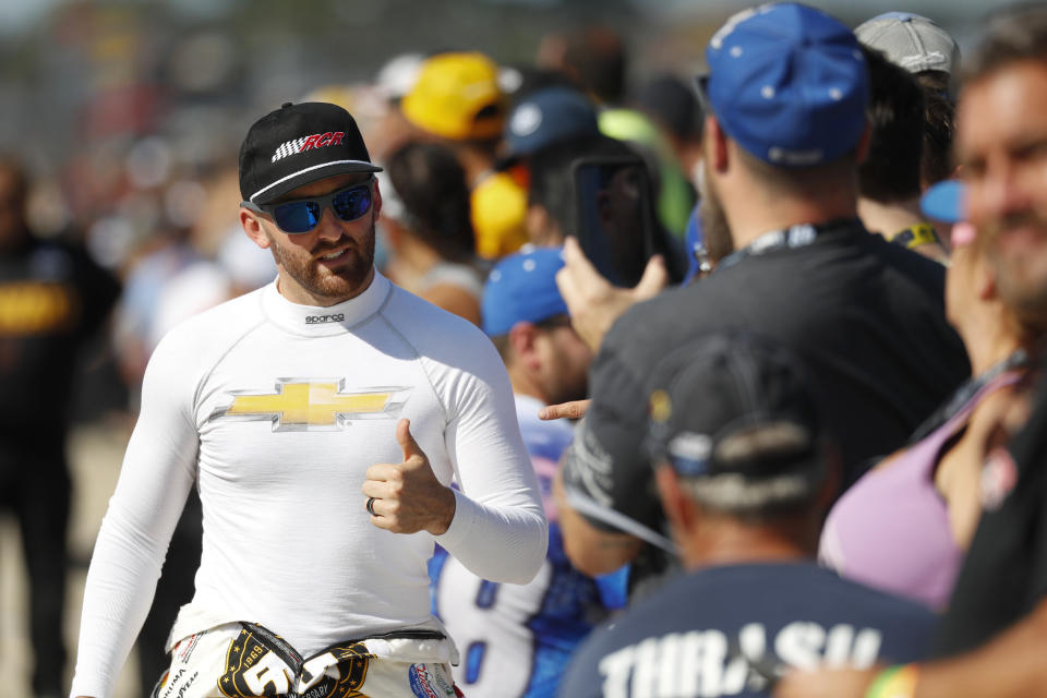 Austin Dillon gives a thumbs-up for a fan after practice for the NASCAR Cup Series auto race at Michigan International Speedway in Brooklyn, Mich., Friday, Aug. 9, 2019. (AP Photo/Paul Sancya)