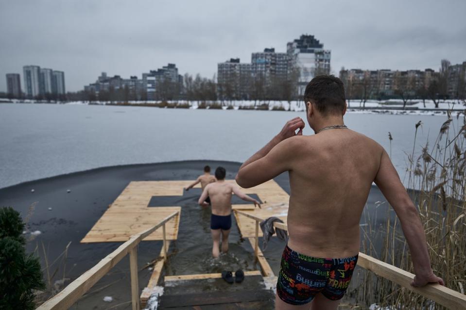 People plunge into the waters of the Dnipro River in Kyiv, Ukraine, to celebrate Epiphany on Jan. 6, 2024. (Kostiantyn Liberov/Libkos/Getty Images)