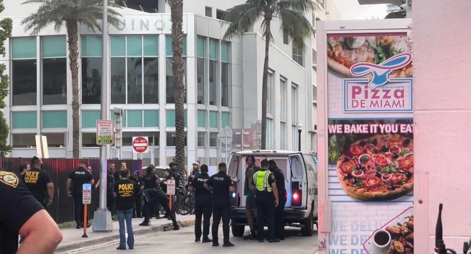 Miami Beach police officers detain a man on Collins Avenue and Sixth Street Saturday.