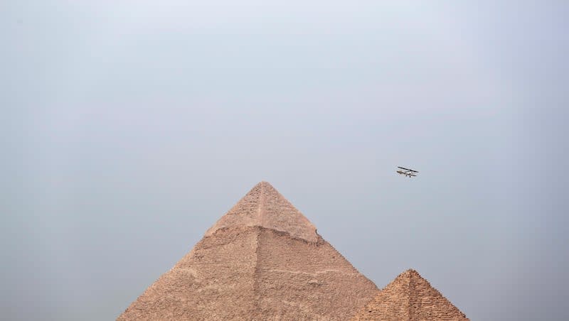 Egyptian medical doctor and pilot Yasser Mohammed Minsy and Belgian commercial pilot Cedric Collette fly a vintage airplane during a rally across Africa, at the Giza Pyramids in Egypt, Sunday, Nov. 13, 2016. A new research paper claims that ancient branches of the Nile River once created river harbors near Egypt’s largest pyramid field.