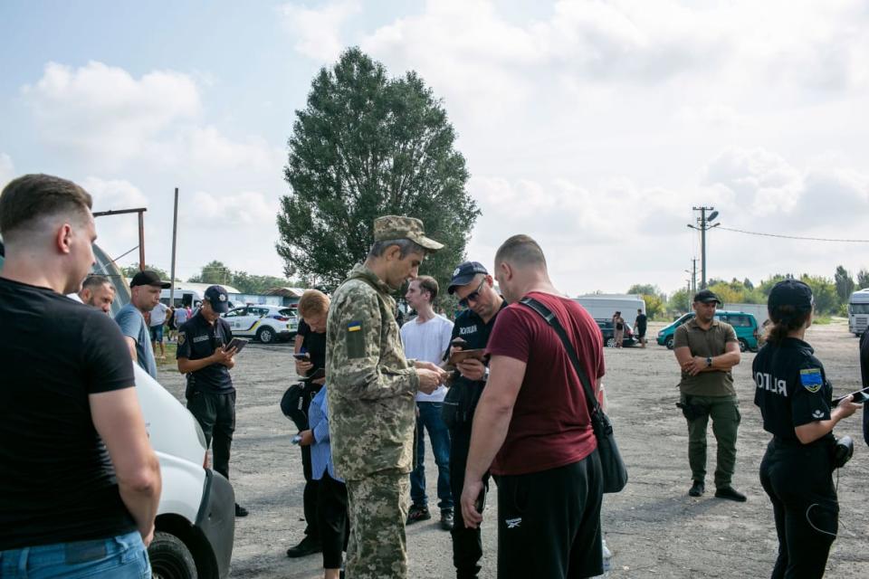 <div class="inline-image__caption"><p>Ukrainian Security personnel check papers from Ukrainians as they register to enter Russian-occupied territories.</p></div> <div class="inline-image__credit">Asmaa Waguih</div>