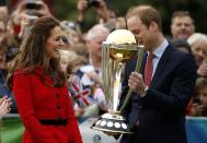 Catherine, the Duchess of Cambridge, laughs as her husband Britain's Prince William holds the Cricket World Cup trophy during a promotional event in Christchurch April 14, 2014. The Prince and his wife Kate are undertaking a 19-day official visit to New Zealand and Australia with their son George REUTERS/Phil Noble (NEW ZEALAND - Tags: ROYALS ENTERTAINMENT POLITICS)