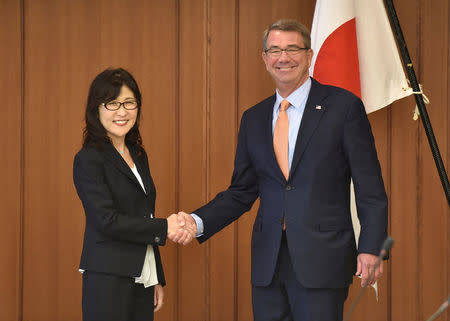 U.S. Defense Secretary Ash Carter and Japan's Defense Minister Tomomi Inada (L) shake hands before their meeting at the Defense Ministry in Tokyo, Japan, December 7, 2016. REUTERS/Kazuhiro Nogi/Pool