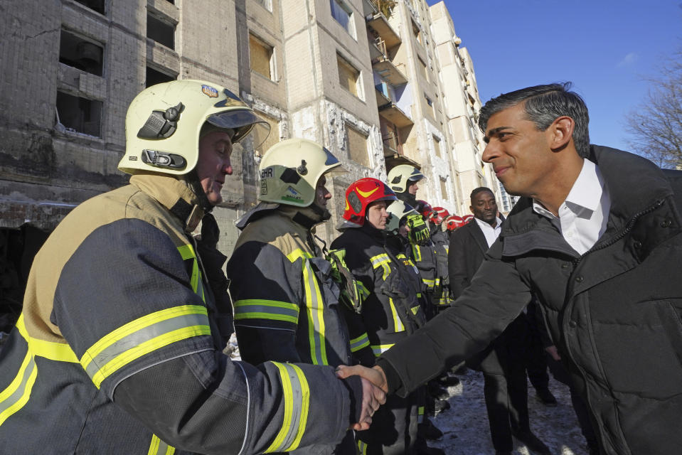 Prime Minister Rishi Sunak talks to firefighters in Kyiv, Ukraine, ahead of meeting with President Volodymyr Zelenskyy to announce a major new package of military aid to Ukraine, Friday, Jan. 12, 2024. (Stefan Rousseau/Pool via AP)