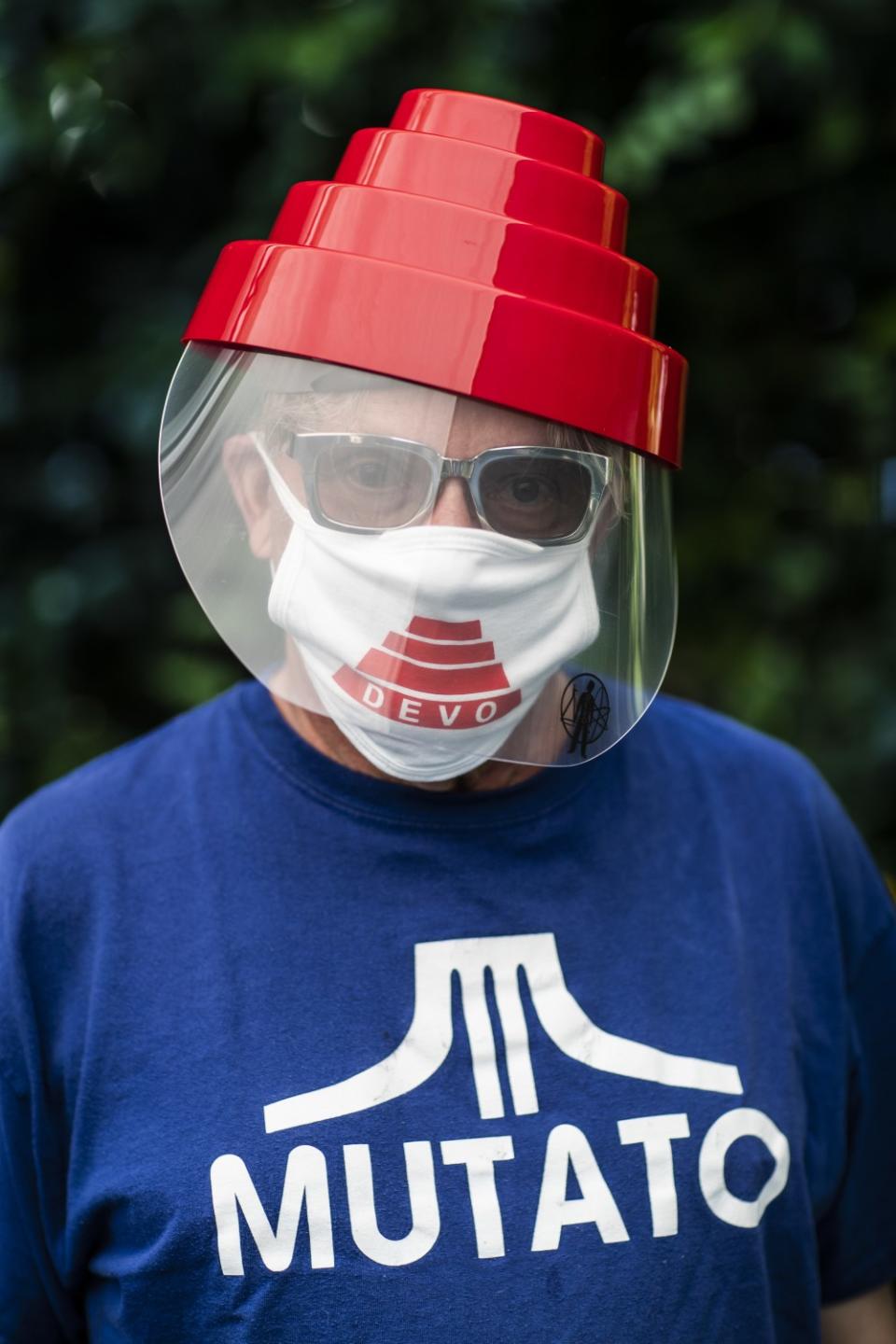 Mark Mothersbaugh survived Covid-19 and is recovering at home. He is photographed wearing official Devo ppe.
