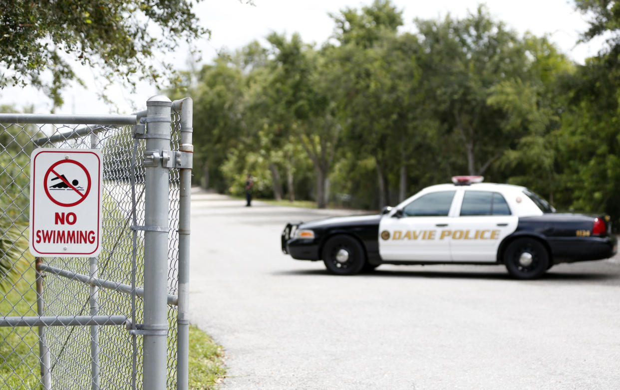 Police block the entrance to Silver Lakes Rotary Nature Park in Davie, Fla., on Friday. (Photo: Wilfredo Lee/AP)