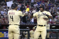 Arizona Diamondbacks' Stone Garrett celebrates with Ketel Marte (4) after hitting a two-run home run against the San Francisco Giants during the third inning of a baseball game Friday, Sept. 23, 2022, in Phoenix. (AP Photo/Rick Scuteri)