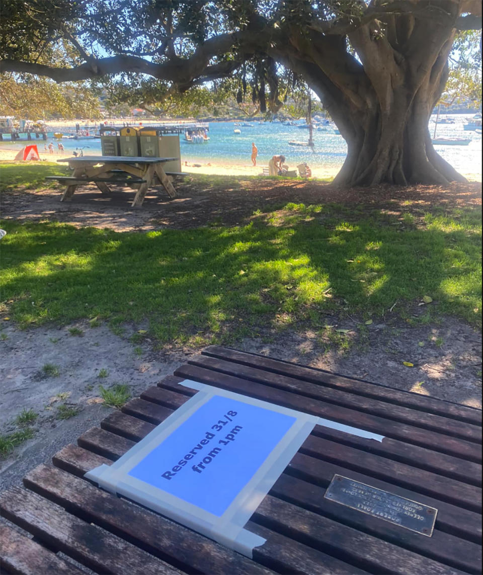 Picnic table Balmoral Beach with reserve sign on it. 