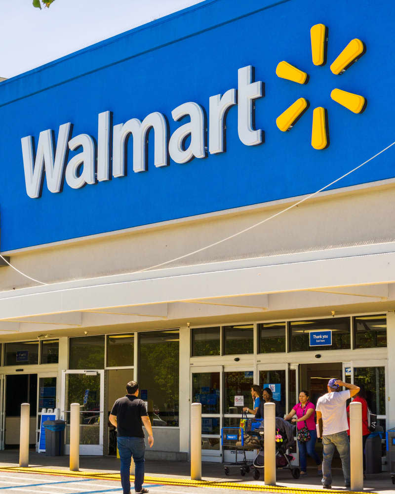 People going in and coming out of a Walmart store on a sunny day, south San Francisco bay area