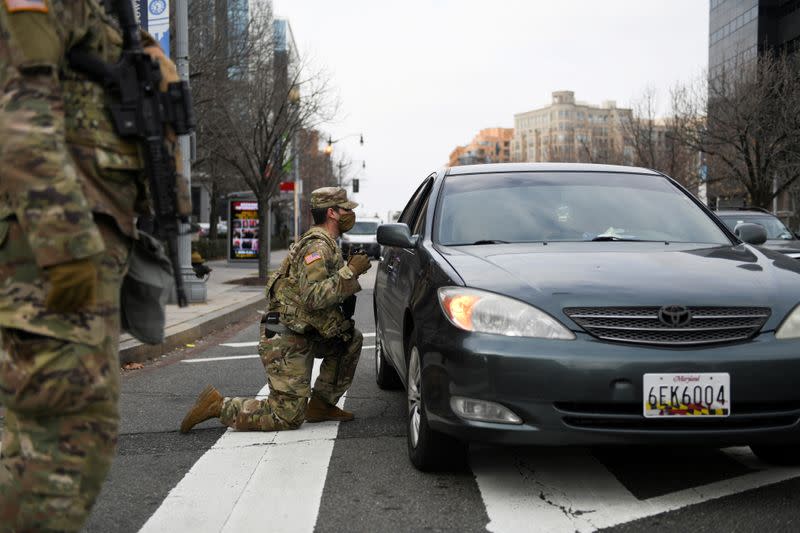 FILE PHOTO: Members of the National Guard assist traffic in downtown Washington D.C., ahead of U.S. President-elect Joe Biden's inauguration