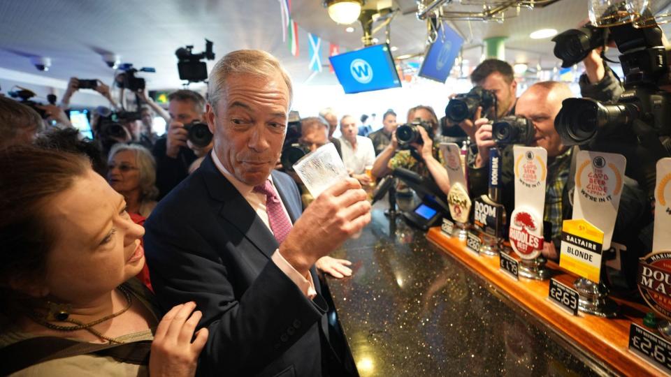 Nigel Farage holding a beer glass
