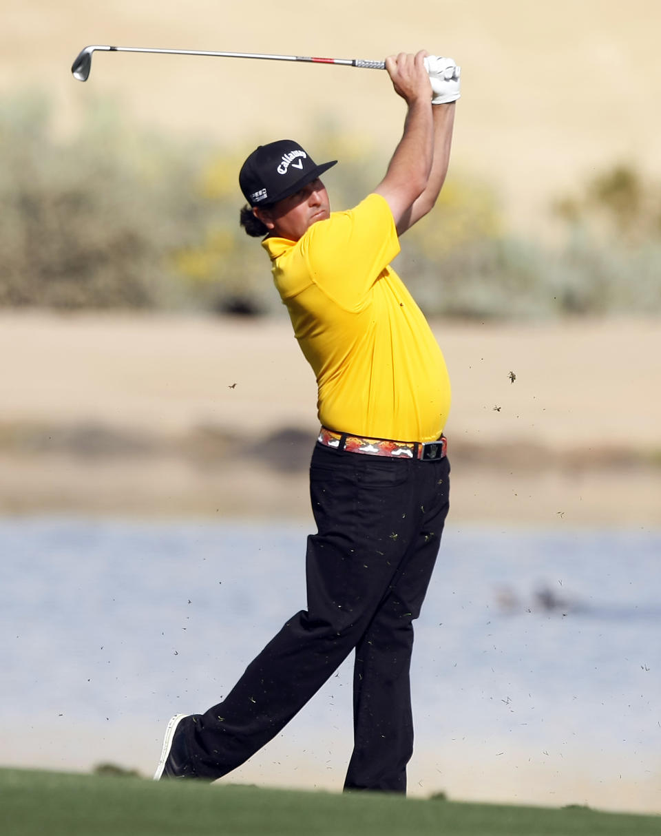 Pat Perez hits his second shot on the 15th hole during the first round of the Waste Management Phoenix Open golf tournament on Thursday, Jan. 30, 2014, in Scottsdale, Ariz. (AP Photo/Rick Scuteri)