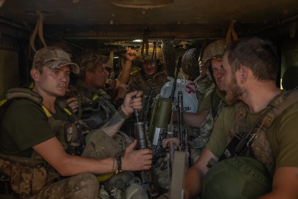 Ukrainian soldiers with their weapons wait inside a US-made M113 armoured personnel carrier to depart for the front in an undisclosed area in the Donetsk region (AFP via Getty Images)