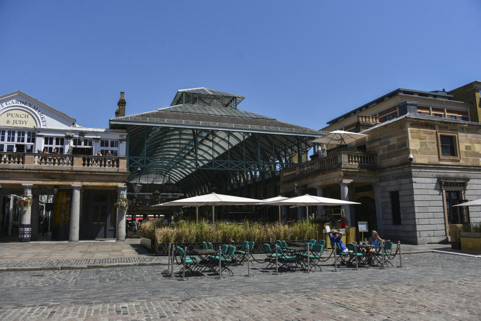 General view of a near empty Covent Garden as many tourist attraction still see a small number of visitors, in London, Friday, July 31, 2020. The Met Office have predicted that parts of the UK will be hotter than mainland Europe this weekend. Temperatures were expected to reach mid 30 Degrees Celsius in many parts of the country on Friday. (AP Photo/Alberto Pezzali)