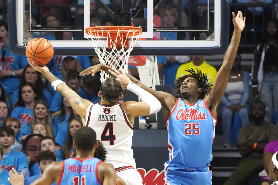Mississippi forward Rashaud Marshall (25) tries to block a layup-attempt by Auburn forward Johni Broome (4) during the second half of an NCAA college basketball game, Saturday, Feb. 3, 2024, in Oxford, Miss. (AP Photo/Rogelio V. Solis)