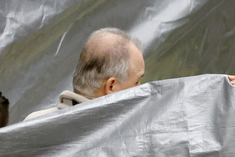 A man who appears to be Michael Taylor, arrives at Narita Airport in Narita, east of Tokyo, Tuesday, March 2, 2021. Two Americans suspected of helping former Nissan Chairman Carlos Ghosn skip bail and escape to Lebanon in December 2019 have been extradited to Japan. Taylor and his son Peter had been held in a suburban Boston jail since May. They were handed over to Japanese custody on Monday and were due to arrive in Tokyo on Tuesday. (Sadayuki Goto/Kyodo News via AP)