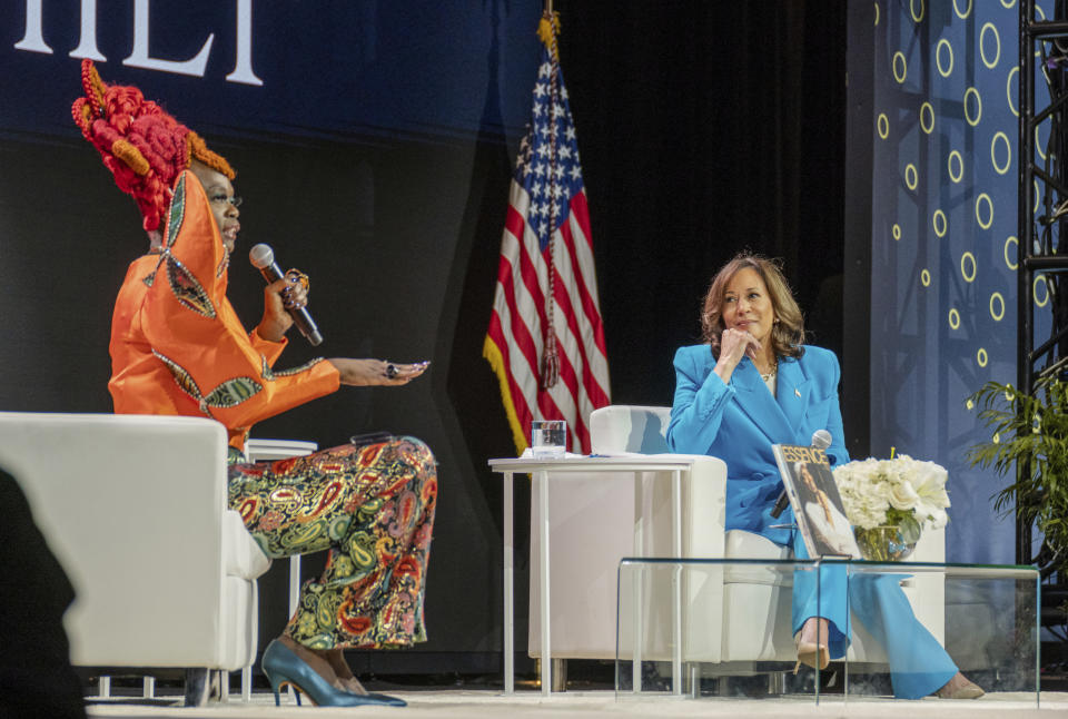 Vice President Kamala Harris, right, listens as Essence CEO Caroline Wanga speaks during the 30th annual Essence Festival of Culture in New Orleans, Saturday, July 6, 2024. (Matthew Perschall/The Times-Picayune/The New Orleans Advocate via AP)