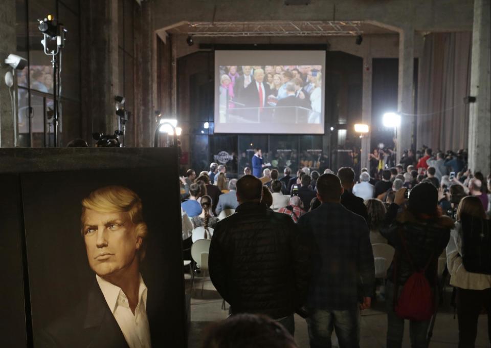 People watch the presidential inauguration ceremony for Donald Trump in a network and party location in Moscow, Russia, Friday, Jan. 20, 2017. A hundred Trump sympathizers, nationalist activists and spin doctors gathered at a hipster party location several hundred meters away from the Kremlin to celebrate. (AP Photo/Ivan Sekretarev)