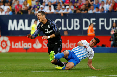 Football Soccer - Malaga v Real Madrid - Spanish Liga Santander - La Rosaleda, Malaga, Spain - 21/5/17 Real Madrid’s Cristiano Ronaldo is challenged by Malaga's Federico RiccaReuters / Jon Nazca