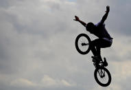 A BMX stunt performer during qualifying for men's BMX in the London 2012 Olympic Games BMX Track. (US Presswire)