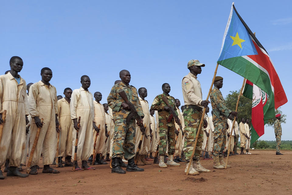 Trainees parade during the visit of the defense minister to a military training center in Owiny Ki-Bul, Eastern Equatoria, South Sudan Saturday, June 27, 2020. At crowded camps in South Sudan, former enemies are meant to be joining forces and training as a unified security force after a five-year civil war so they can help the shattered country recover but they can barely find enough food. (AP Photo/Maura Ajak)