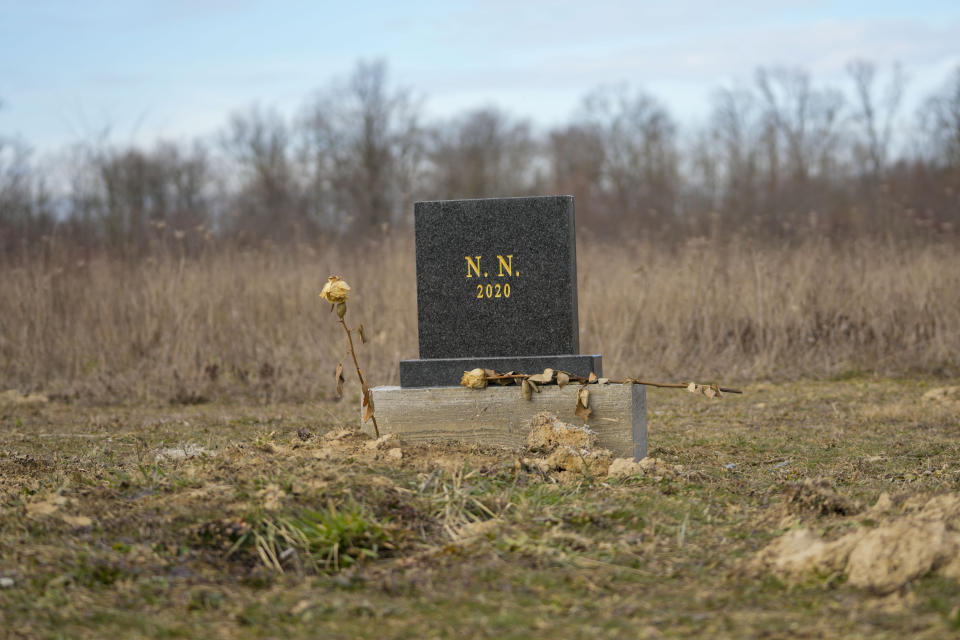 A gravestone with the inscription "N.N."(Nomen nescio), used to signify an anonymous or unnamed person, is adorned with a flower is seen at the cemetery in Bijeljina, eastern Bosnia, Sunday, Feb. 4, 2024. In several cities along this river between Bosnia and Serbia, simple, durable gravestones now mark the final resting places of dozens of refugees and migrants who drowned in the area while trying to reach Western Europe. (AP Photo/Darko Vojinovic)