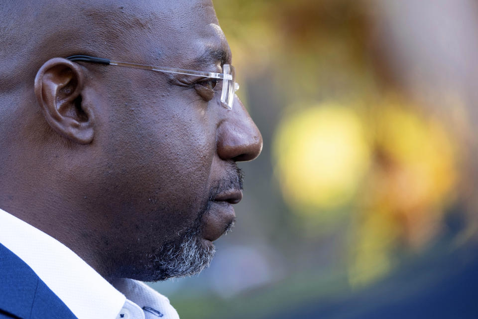 U.S. Sen, Raphael Warnock, D-Ga., speaks to journalists after voting on the first day of early voting in Atlanta on Monday, Oct. 17, 2022. (AP Photo/Ben Gray)