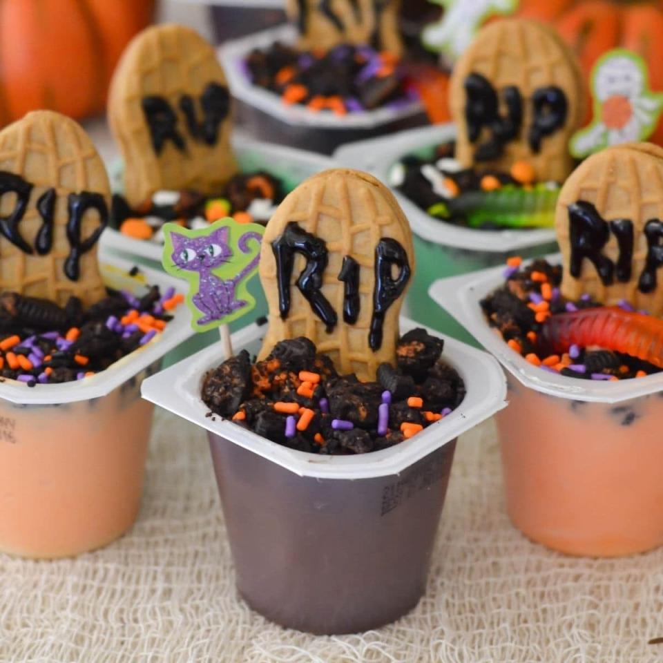 <p>For a portable Halloween treat the kids can snack on while watching their favorite <a href="https://www.womansday.com/life/g3104/kids-halloween-movies/" rel="nofollow noopener" target="_blank" data-ylk="slk:Halloween movie;elm:context_link;itc:0;sec:content-canvas" class="link ">Halloween movie</a>, prepare these cups.</p><p>Get the <strong><a href="https://flouronmyface.com/easy-halloween-graveyard-pudding-cups/" rel="nofollow noopener" target="_blank" data-ylk="slk:Halloween Graveyard Pudding Cups recipe;elm:context_link;itc:0;sec:content-canvas" class="link ">Halloween Graveyard Pudding Cups recipe</a> </strong>at Flour On My Face.</p>