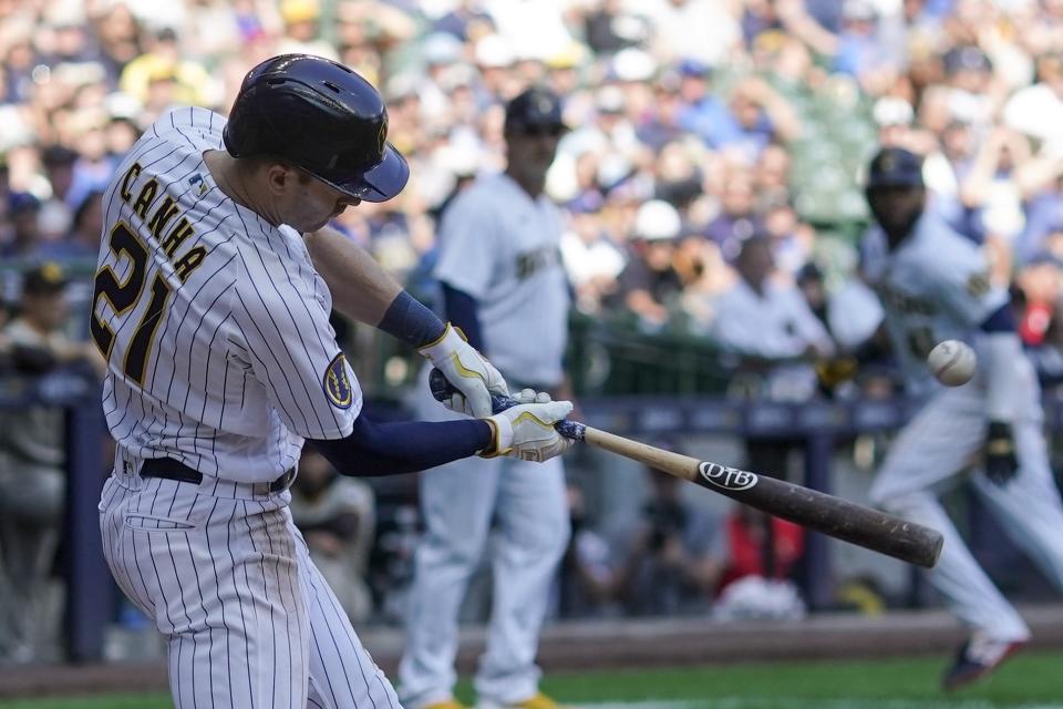 Milwaukee Brewers' Mark Canha hits a two-run scoring single during the sixth inning of a baseball game against the San Diego Padres Sunday, Aug. 27, 2023, in Milwaukee. (AP Photo/Morry Gash)