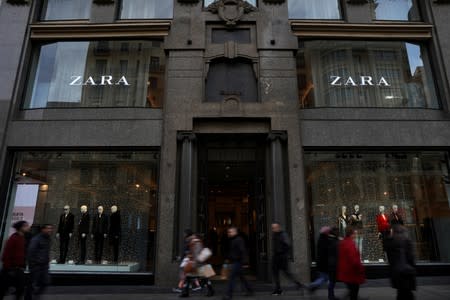 FILE PHOTO: People walk past a Zara store, an Inditex brand, in central Madrid