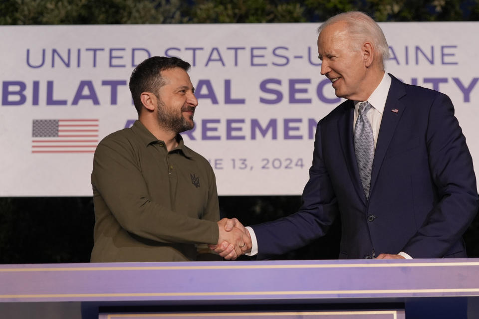 President Joe Biden and Ukrainian President Volodymyr Zelenskyy, left, shake hands after signing a security agreement on the sidelines of the G7, Thursday, June 13, 2024, in Savelletri, Italy. (AP Photo/Alex Brandon)