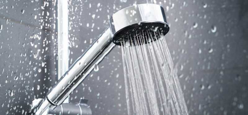 A showerhead with water flowing.