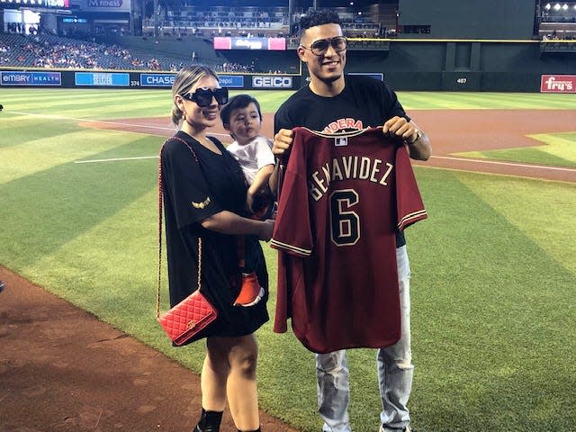 Boxer David Benavidez, of Phoenix, with his family prior to him throwing out the ceremonial first pitch Sunday at Chase Field.