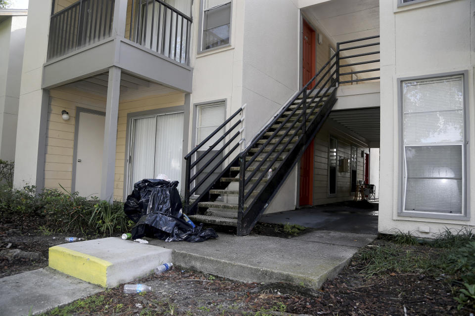 Items are strewn about outside the Enclave on East Apartments, Wednesday, Sept. 5, 2018, in Largo, Fla., where police say they found evidence related to the death of a 2-year-old Jordan Belliveau. Largo police arrested the boys mother, 21-year-old Charisse Stinson, late Tuesday. She's charged with first-degree murder in the death of Jordan Belliveau and is being held in the Pinellas County Jail. (Douglas R. Clifford/Tampa Bay Times via AP)
