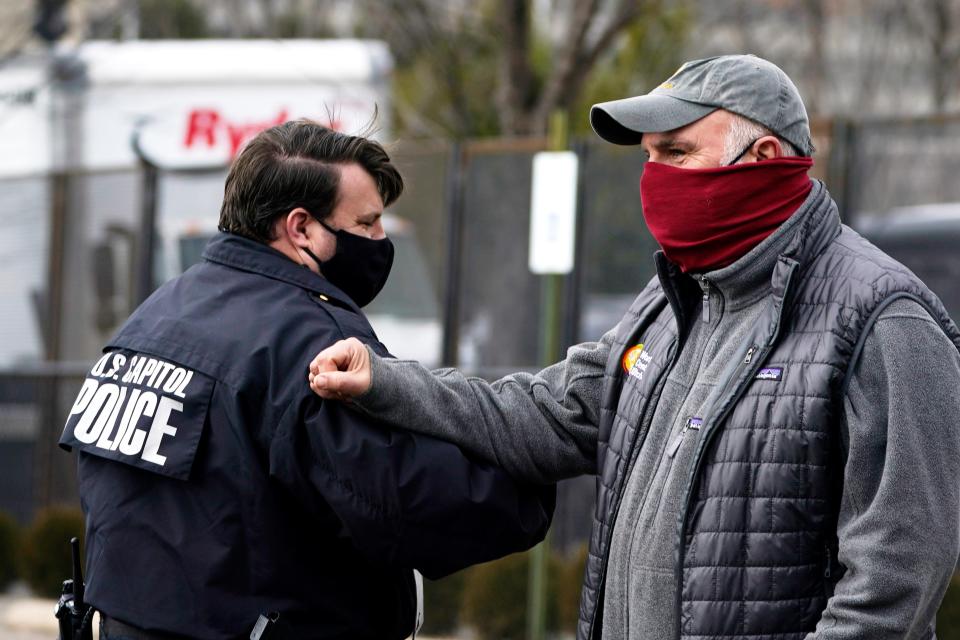 Chef Jose Andres, founder of World Central Kitchen, talks and bumps elbows with a U.S. Capitol Police officer while handing out food to those protecting the Nation's Capital ahead of the inauguration of President-elect Joe Biden and Vice President-elect Kamala Harris, Sunday, Jan. 17, 2021, in Washington.