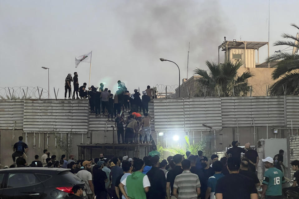 Protesters scale a wall at the Swedish Embassy in Baghdad, Iraq, July 20, 2023. / Credit: Ali Jabar/AP