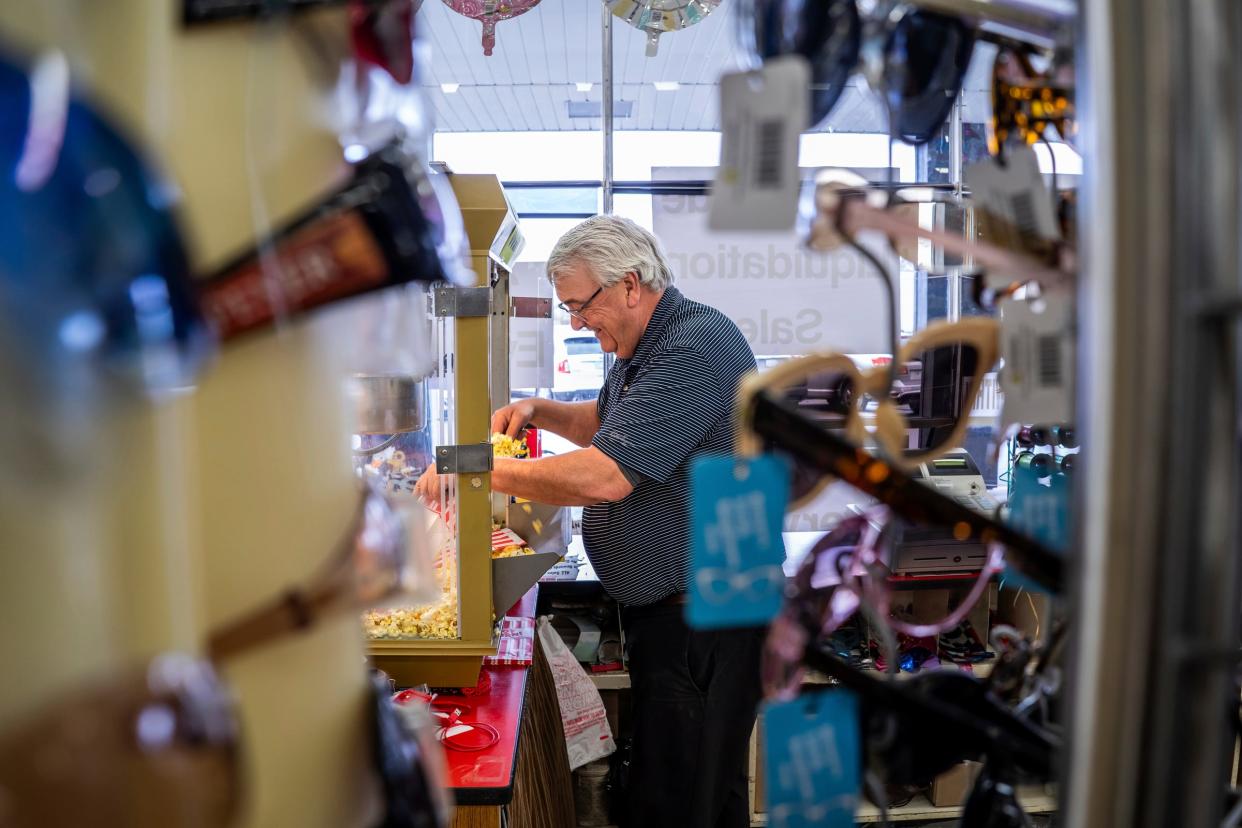 Rod Wells, the longtime manager of Springrove Variety, bags popcorn for customers on Friday, Feb. 2, 2024.