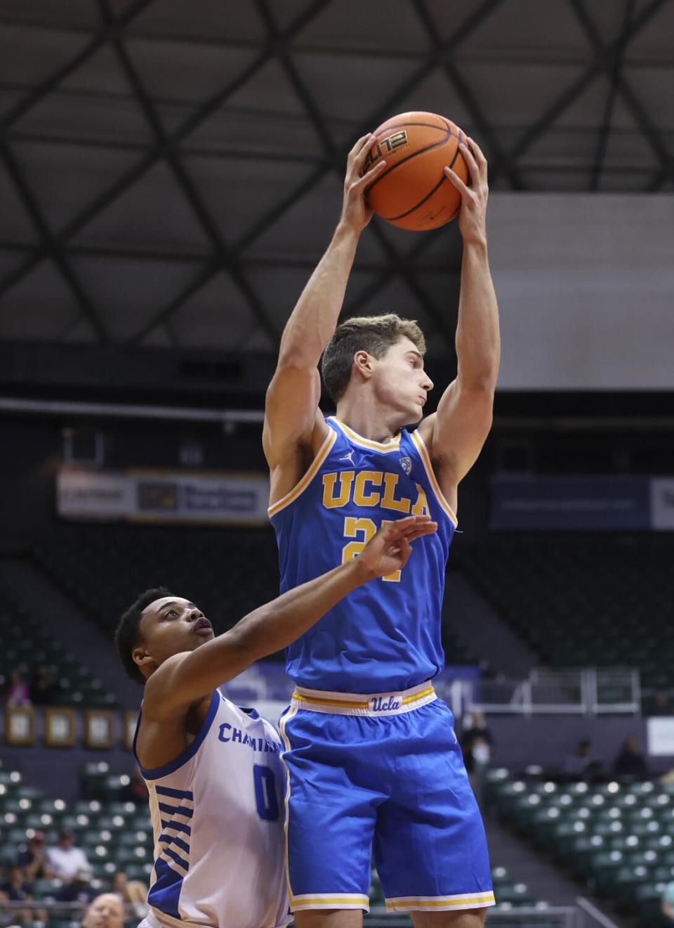 UCLA guard Jan Vide grabs a rebound over Chaminade guard Jamir Thomas.