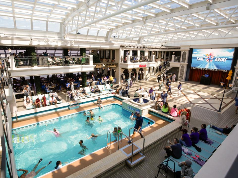 A busy indoor pool on a cruise ship.