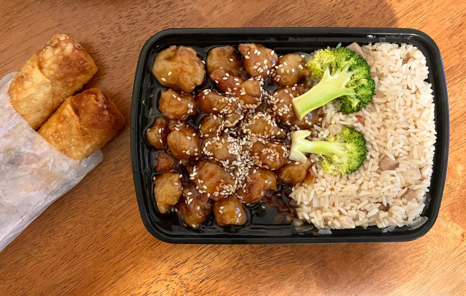 The sesame chicken combo meal comes with pork fried rice and a pork egg roll.