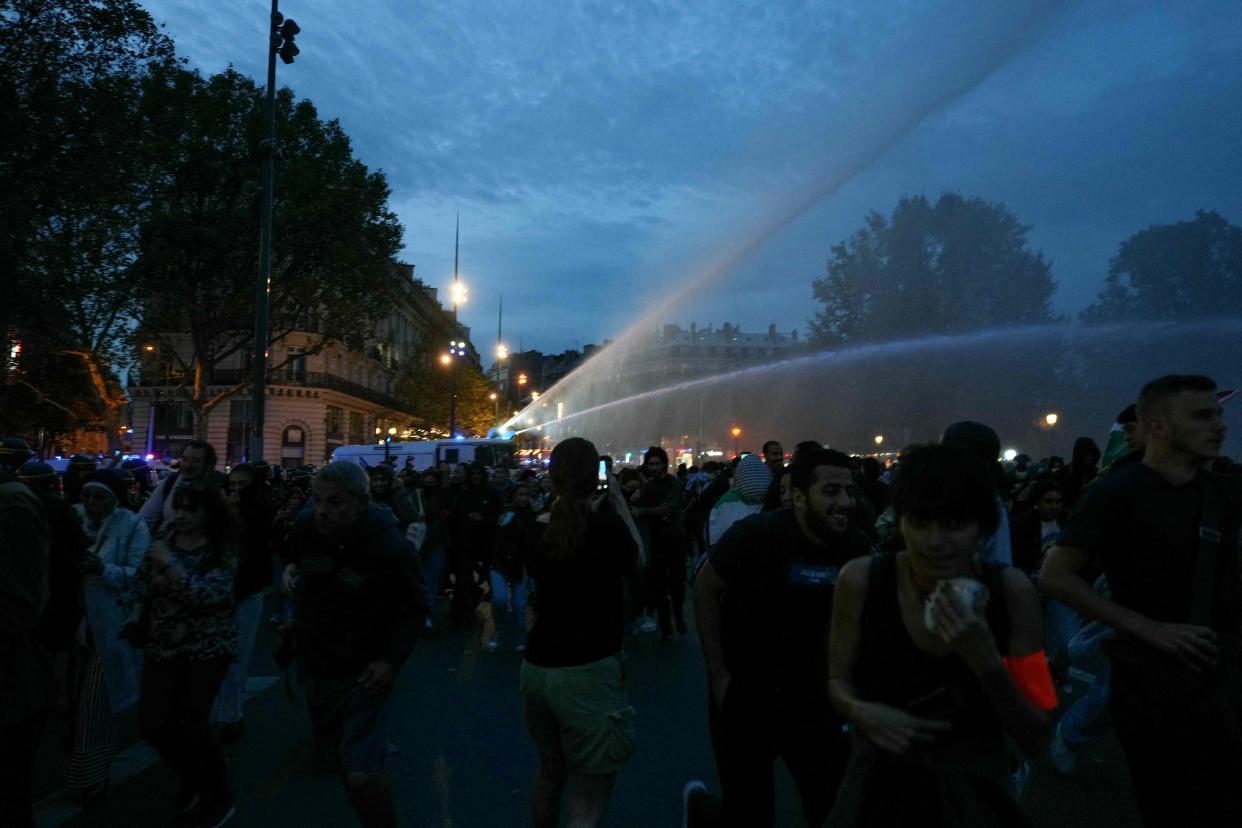 French police fire water cannon towards protestors as they try to disperse an unauthorized demonstration in support of Palestinians at Place de la Republique, in Paris, on 12 October 2023 (AFP via Getty Images)