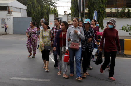 Garment workers leave for home after work at a factory, on the outskirts of Phnom Penh, Cambodia, October 16, 2018. Picture taken October 16, 2018. REUTERS/Samrang Pring