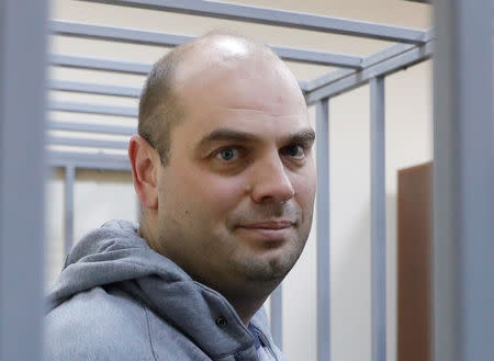 Former Chairman of Vostochny Bank board Alexei Kordichev, who was detained on suspicion of embezzlement, is seen inside a defendants' cage as he attends a court hearing in Moscow, Russia February 15, 2019. REUTERS/Tatyana Makeyeva